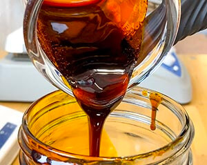 pouring cbd oil in a jar