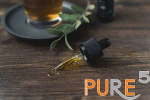 pure and clean cbd oil on a brown wooden table