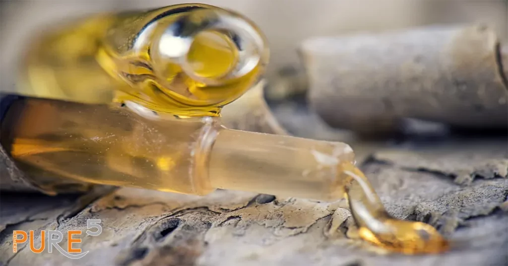 Pure THC distillate pouring from a tube explaining the art of refining cannabis extract