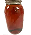 A jar with full spectrum distillate in light-brown color made by PURE5™